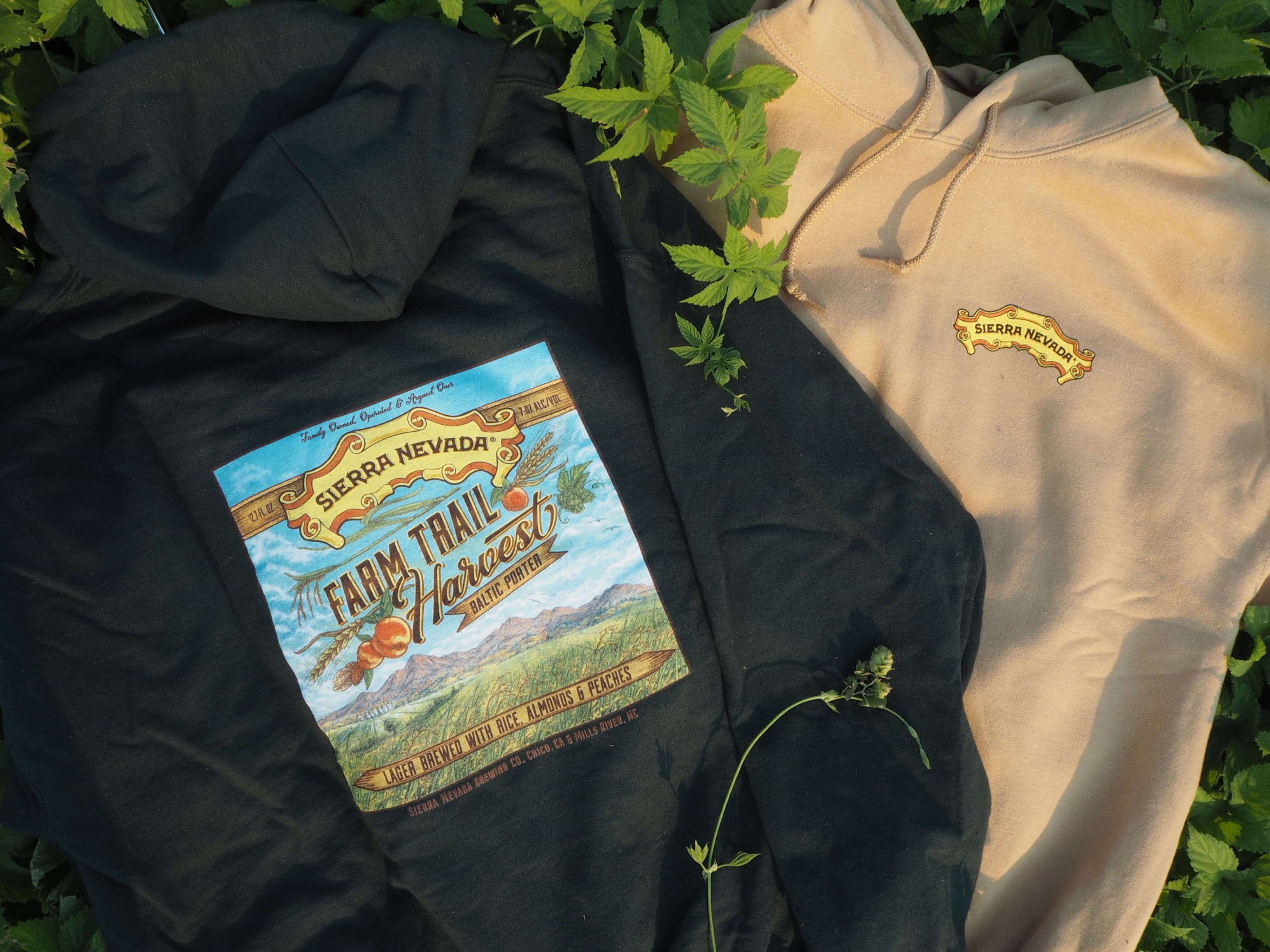 Sierra Oro Farm Trail Green and Gold sweatshirts on a green bush